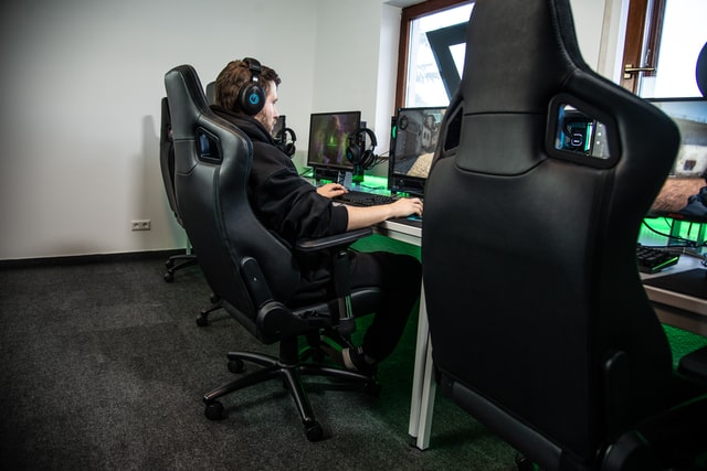 Man siting down on a gaming chair while gaming